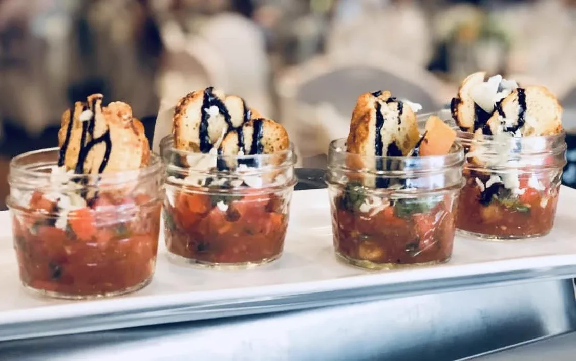 Bruschetta in mini mason jars with balsamic drizzled crostini